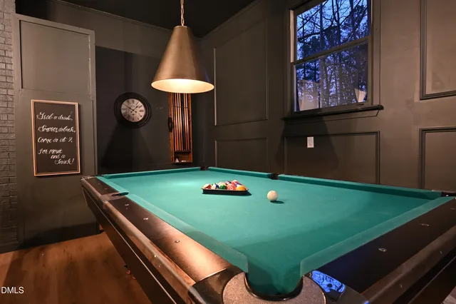 a kitchen with a sink and chairs