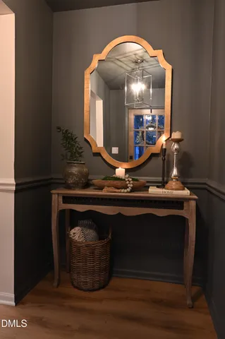 a kitchen with stainless steel appliances granite countertop a refrigerator a stove a sink dishwasher a dining table and chairs with wooden floor