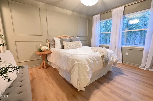 a bathroom with a sink a toilet a mirror and shower