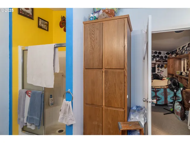 a bathroom with a refrigerator and mirror