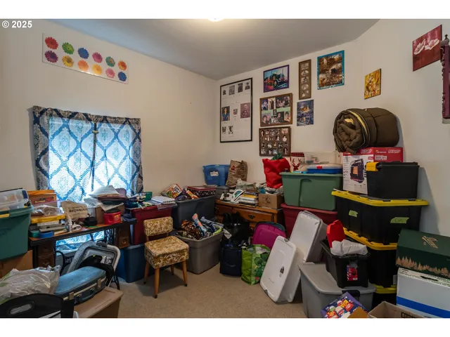 a living room with furniture a rug and a window