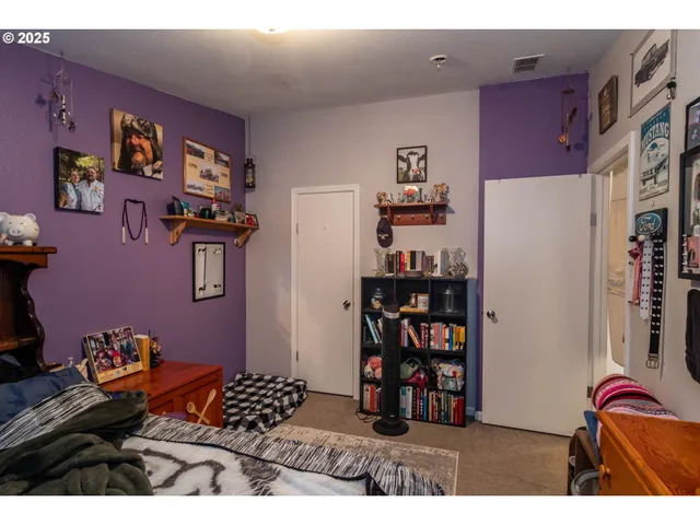 a bedroom with a bed and a book shelf