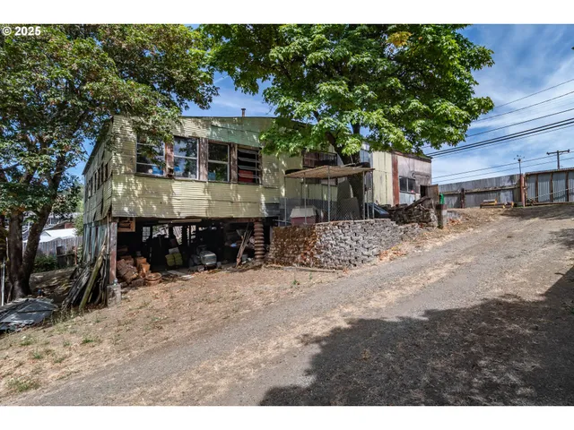 a view of a patio with a table and chairs under an umbrella