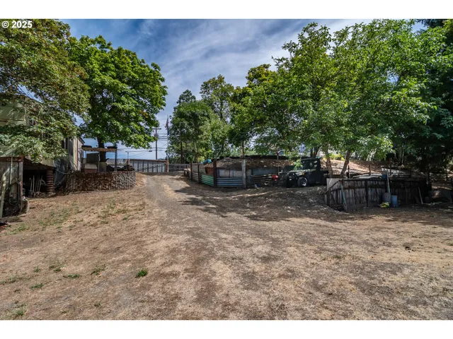 a backyard of a house with barbeque oven table and chairs