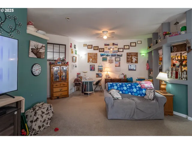 a living room with furniture and painting on the wall