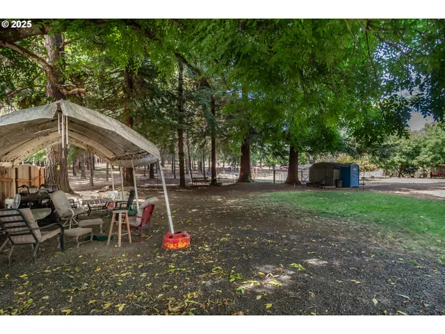 a backyard of a house with table and chairs