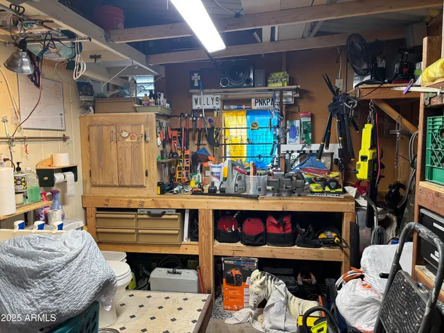 a backyard of a house with table and chairs plants