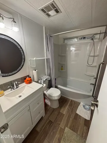 a bathroom with a sink mirror vanity and toilet