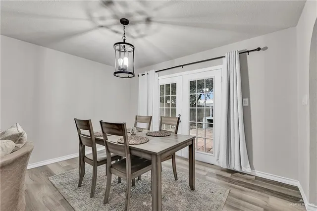 a view of a dining room with furniture wooden floor and chandelier
