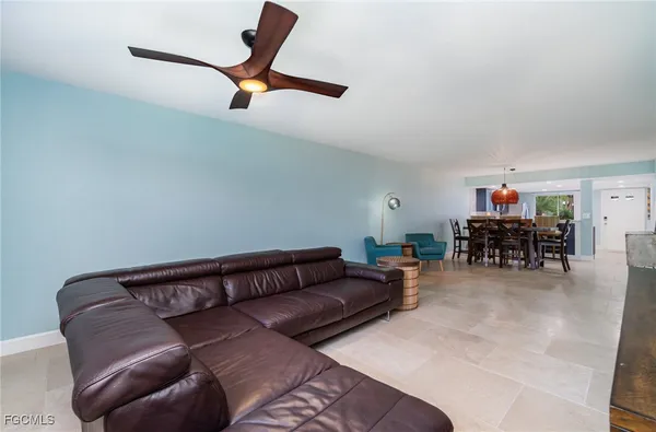 a living room with furniture and a ceiling fan