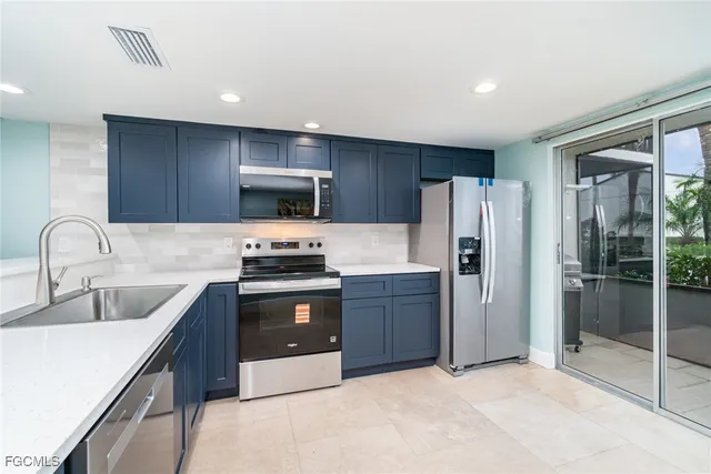 a large kitchen with a large counter top appliances and cabinets