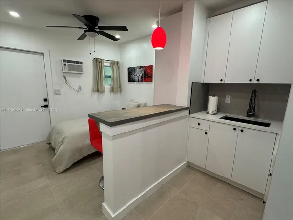 a kitchen that has a microwave a sink and a stove in it