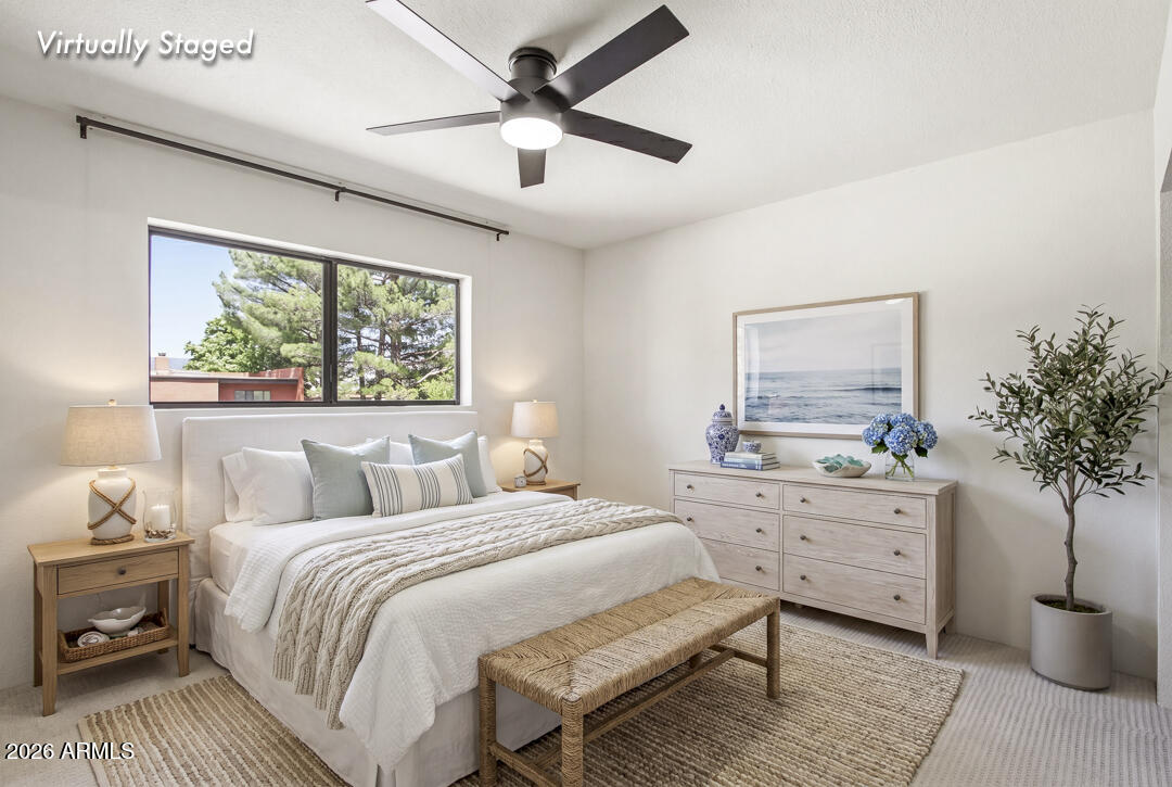 165 Verde Valley School Road, Unit 6 Sedona, AZ 86351 - Photo 29 of 40 a bedroom with a large bed and a chandelier