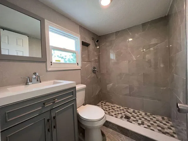 a bathroom with a sink toilet and shower