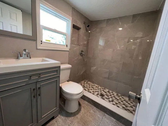 a bathroom with a sink toilet and shower