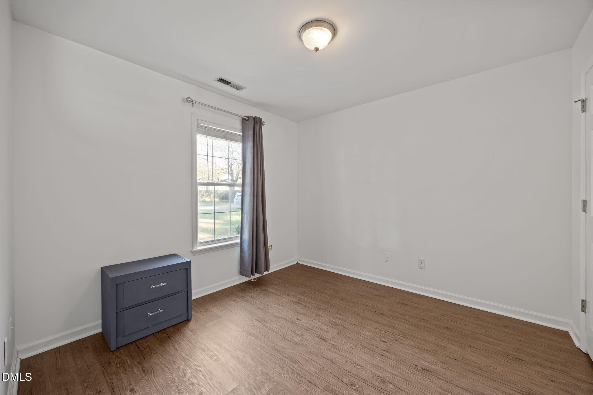 2208 Walnut Ridge Court Raleigh, NC 27610 - Photo 21 of 24 an empty room with wooden floor and windows