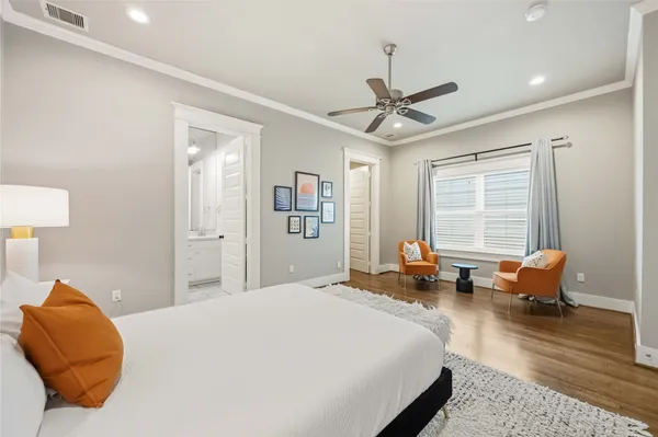 a bedroom with a bed couch and window