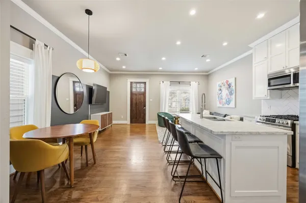 a view of a dining room with furniture and a chandelier