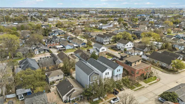 an aerial view of residential houses with city view