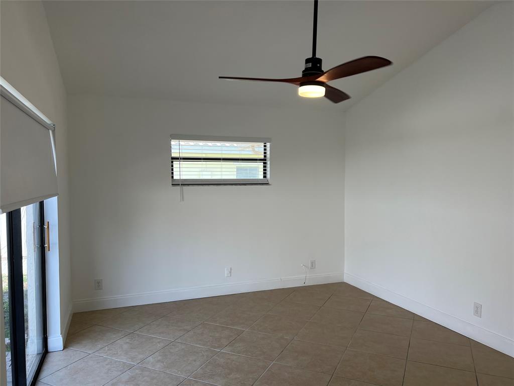 371 Mohawk Lane Boca Raton, FL 33487 - Photo 15 of 26 an empty room with windows and fan