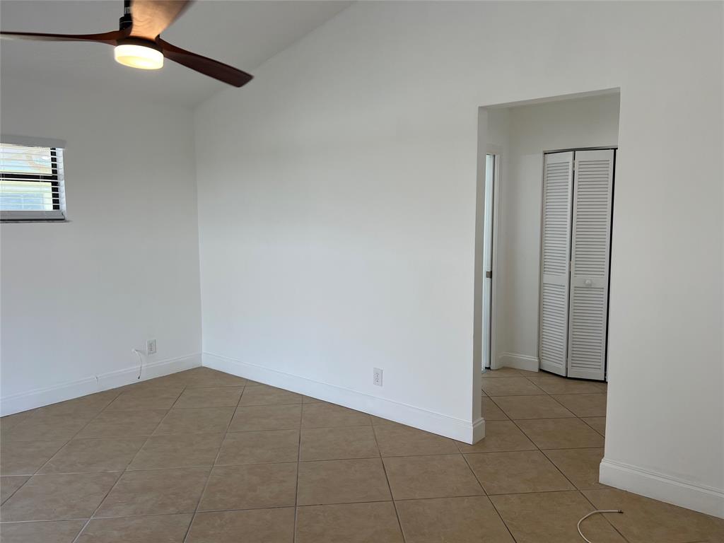371 Mohawk Lane Boca Raton, FL 33487 - Photo 16 of 26 an empty room with a fan & a ceiling fan