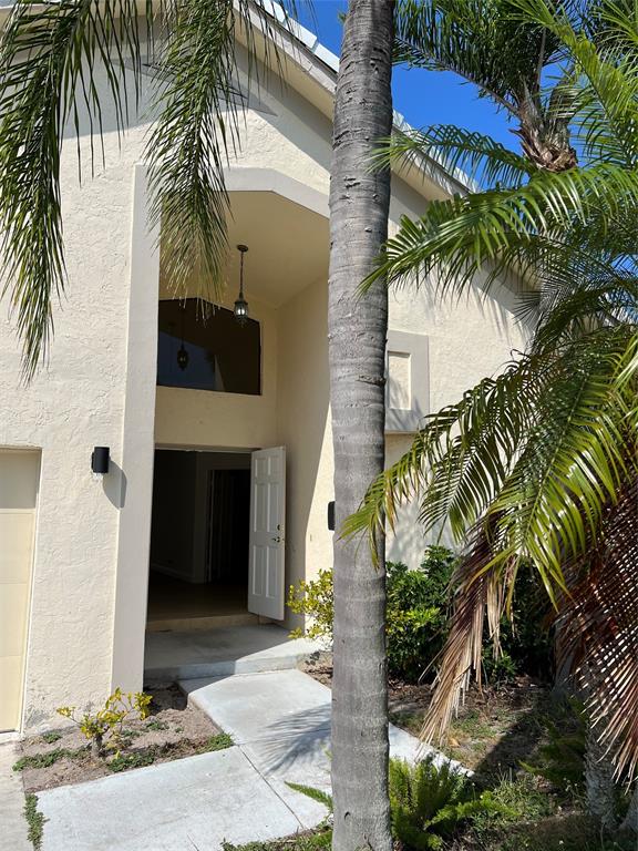 371 Mohawk Lane Boca Raton, FL 33487 - Photo 3 of 26 a view of a palm trees front of a house