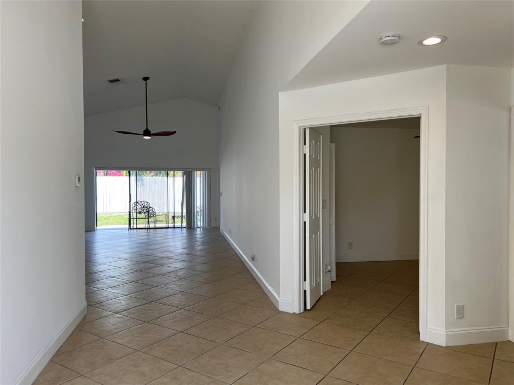 371 Mohawk Lane Boca Raton, FL 33487 - Photo 5 of 26 an empty room with wooden floor and windows