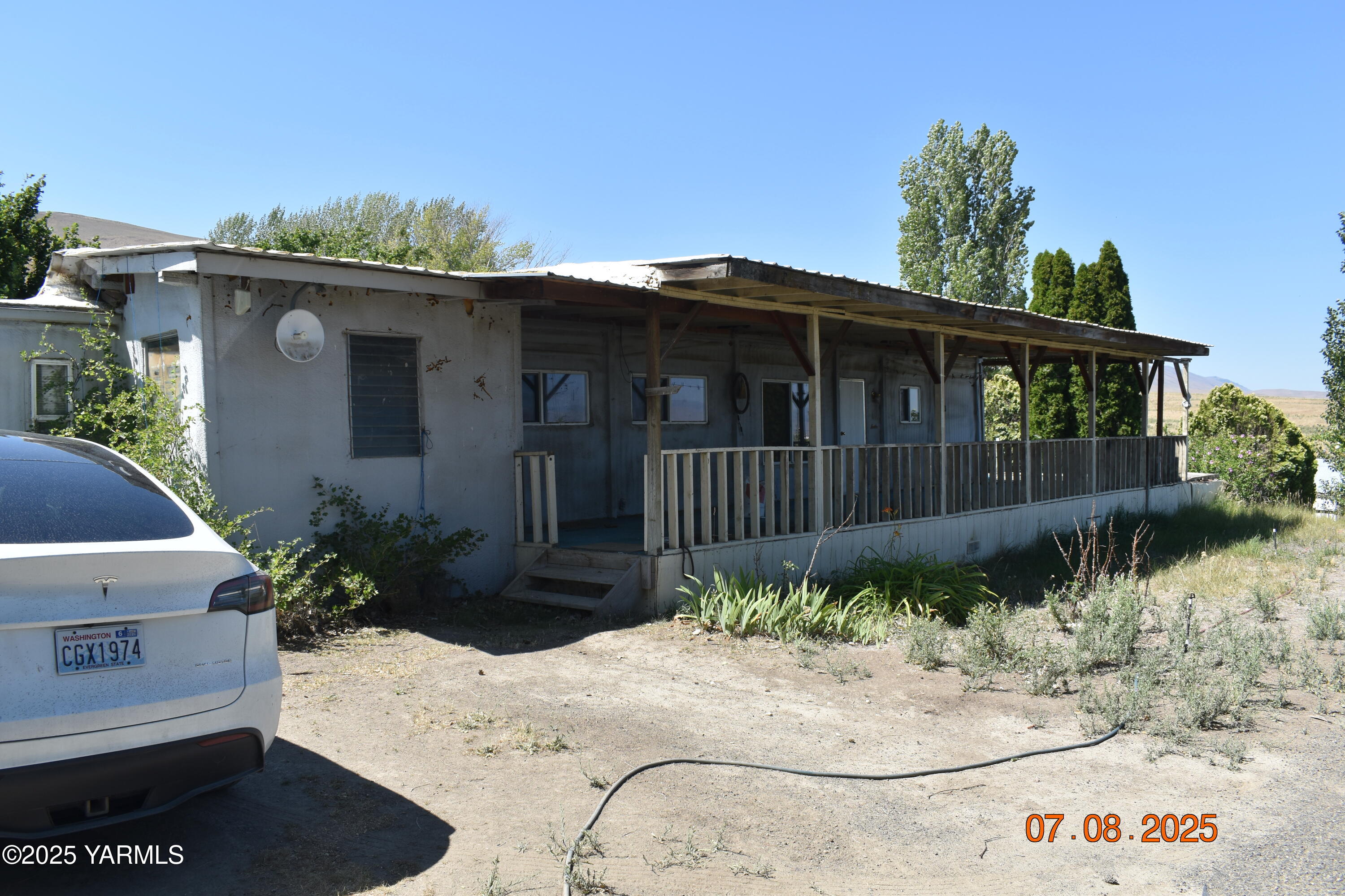 a view of a house with a wooden fence