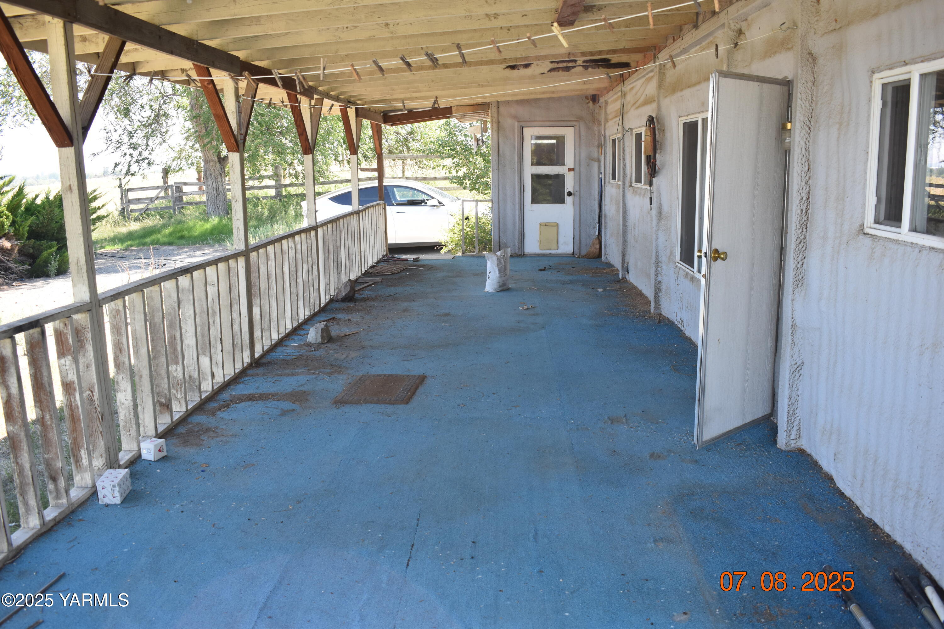 9950 Pumphouse Road Toppenish, WA 98948 - Photo 6 of 17 a view of a porch with wooden floor and outdoor space