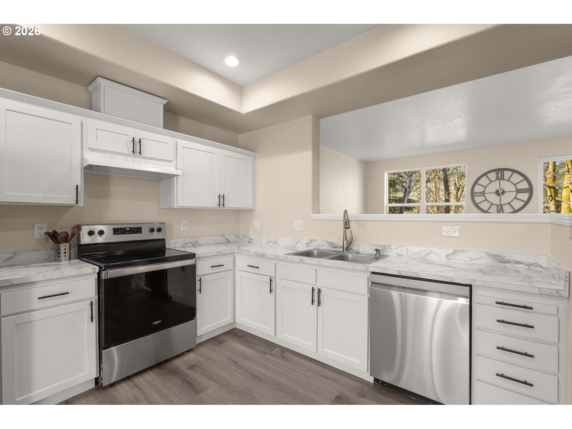 13193 Southwest Raptor Place Tigard, OR 97223 - Photo 3 of 27 a kitchen with stainless steel appliances granite countertop a stove and a sink