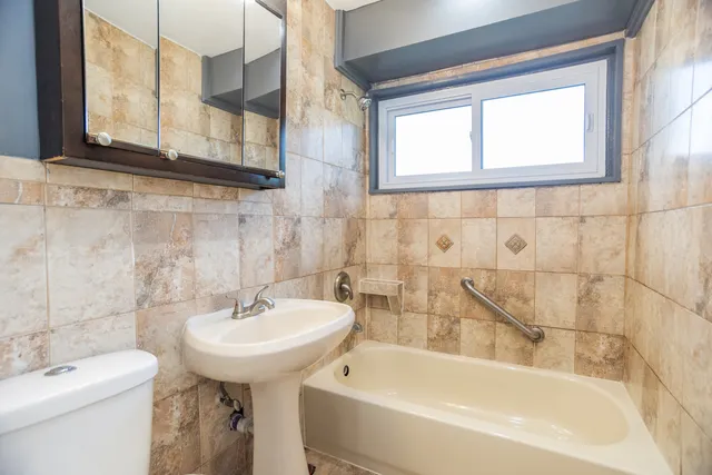 a bathroom with a sink a toilet and bathtub