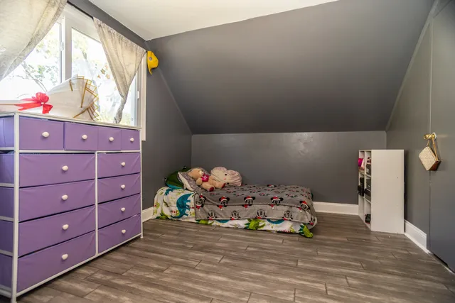 a bedroom with a bed and a dresser