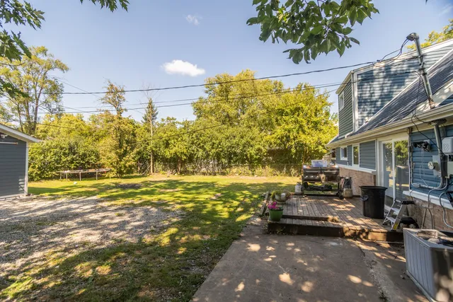 a view of a house with pool and sitting area