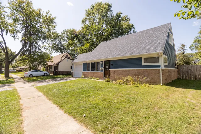 a front view of house with yard and trees