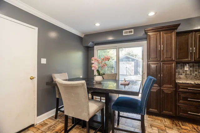 a dining room with furniture and window