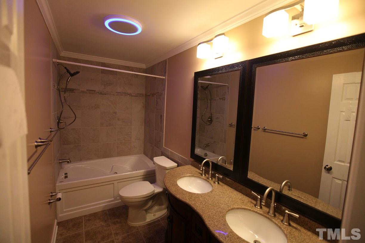 7319 Post Oak Road Raleigh, NC 27615 - Photo 4 of 12 a bathroom with a granite countertop sink toilet and shower