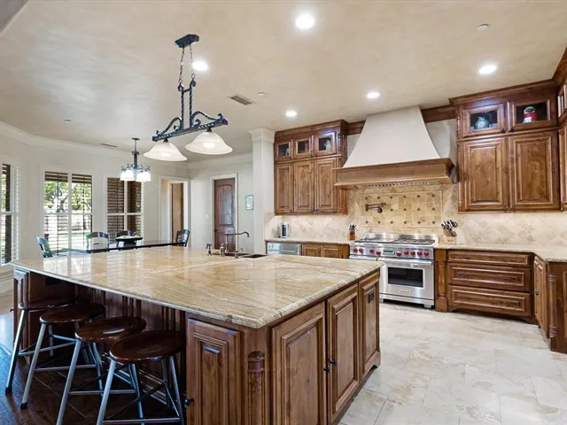 a kitchen with a stove a refrigerator and wooden cabinets
