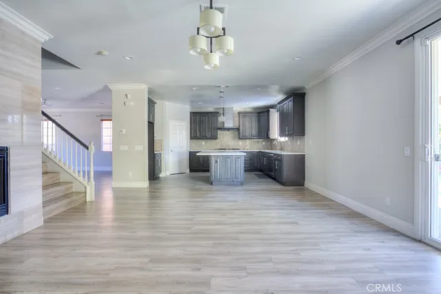 a kitchen with kitchen island granite countertop a sink a counter top space and stainless steel appliances