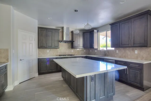 a view of an empty room with wooden floor and closet