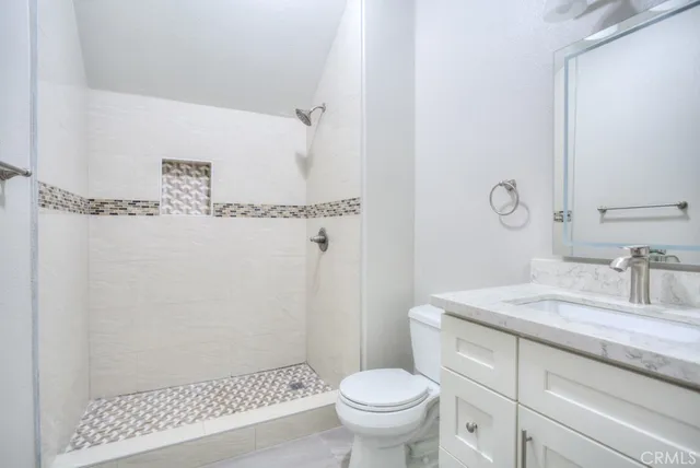 a view of a hallway with wooden floor and windows