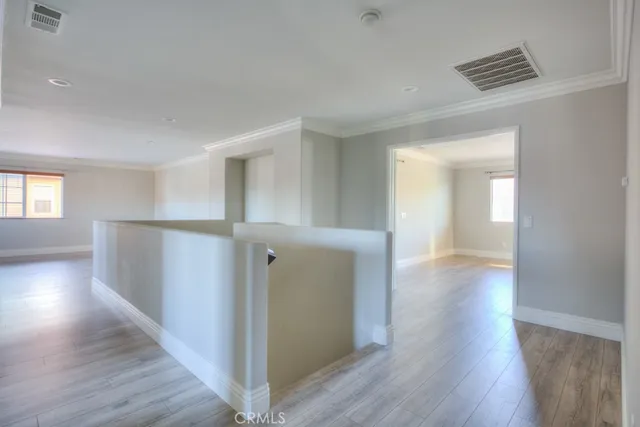 a room with wooden floor and furniture