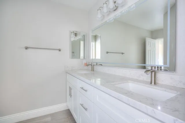 a kitchen with a wooden floor and cabinets