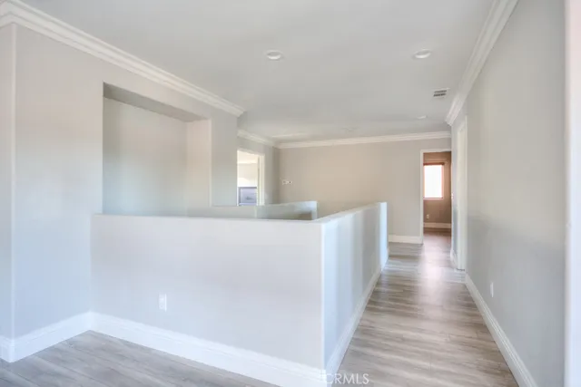 a view of a livingroom with wooden floor and a ceiling fan