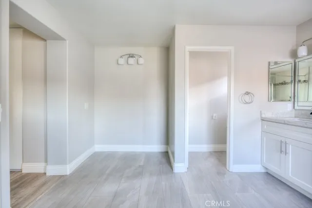 a view of hallway with wooden floor