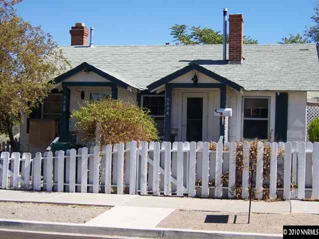 668 Quincy Street Reno, NV 89512 - Photo 2 of 2 a view of a house with wooden fence next to a road