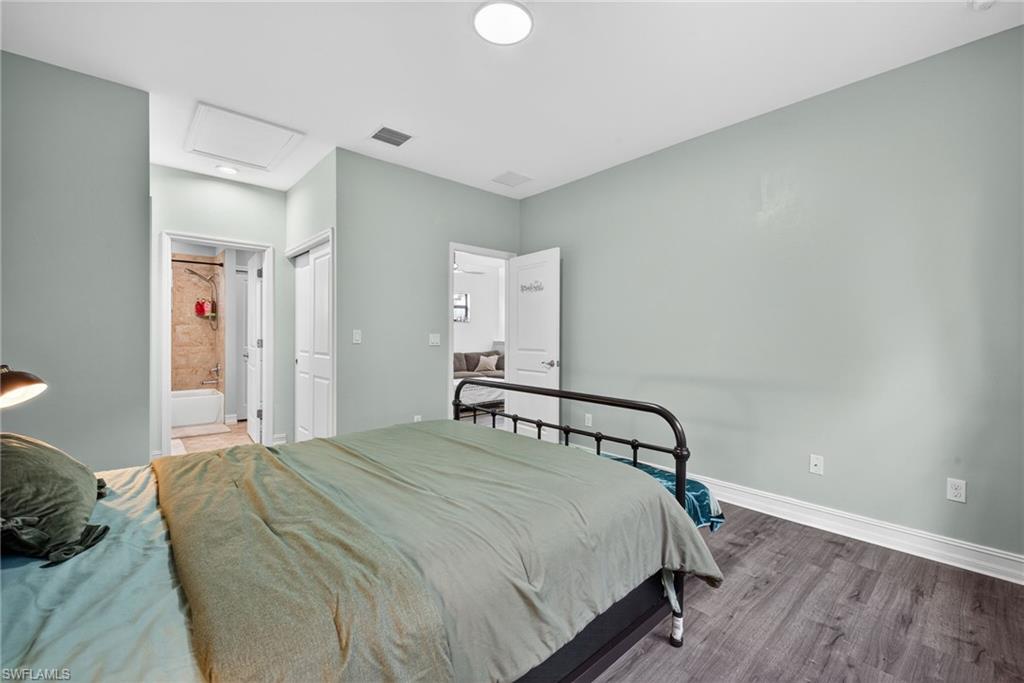 7845 Bristol Circle Naples, FL 34120 - Photo 21 of 31 a bedroom with a bed and cabinets