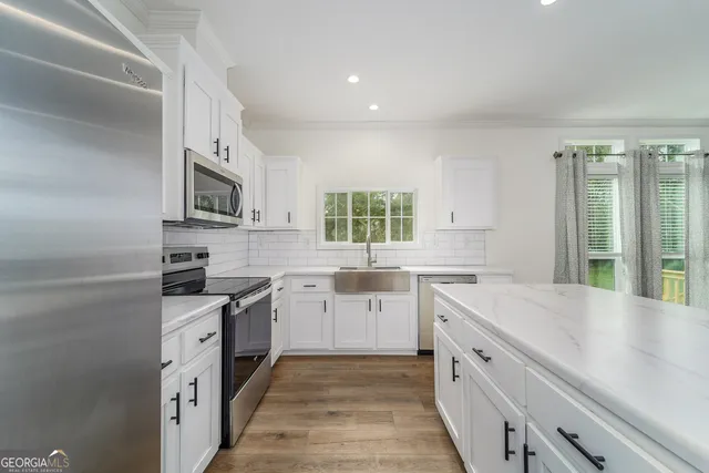 a kitchen with a sink stove and cabinets