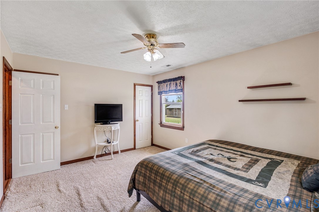 3411 Spring Run Road Mechanicsville, VA 23111 - Photo 13 of 41 a bedroom with a bed and a flat screen tv
