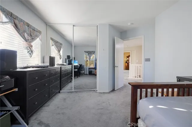 a bathroom with a granite countertop sink a toilet and a mirror