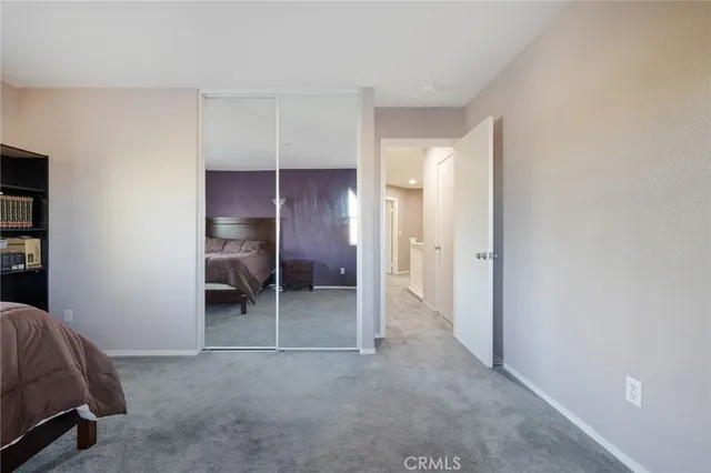 a bedroom with a bed dresser and a window